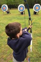 Determined Boy Practicing Archery Journal